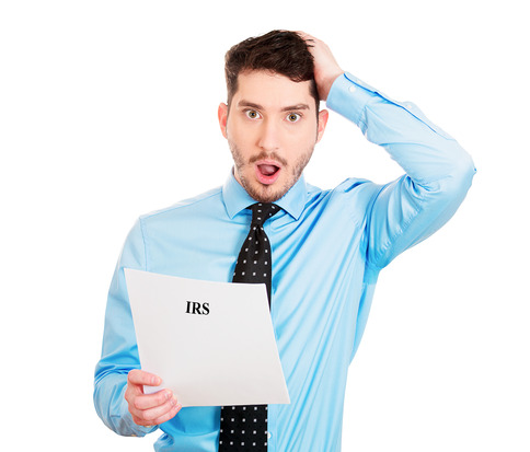 Closeup portrait, sad, shocked funny looking young man disgusted at his IRS statement, isolated white background. Negative human emotion facial expression feelings. Financial crisis, bad news